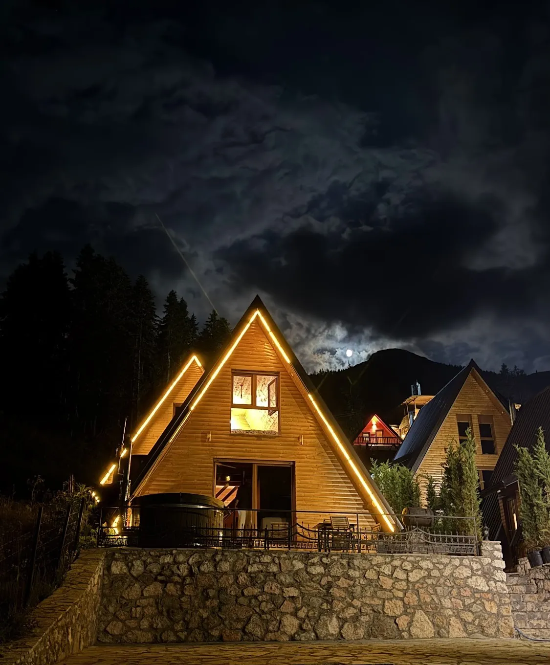 An A-frame outlined in lights at night