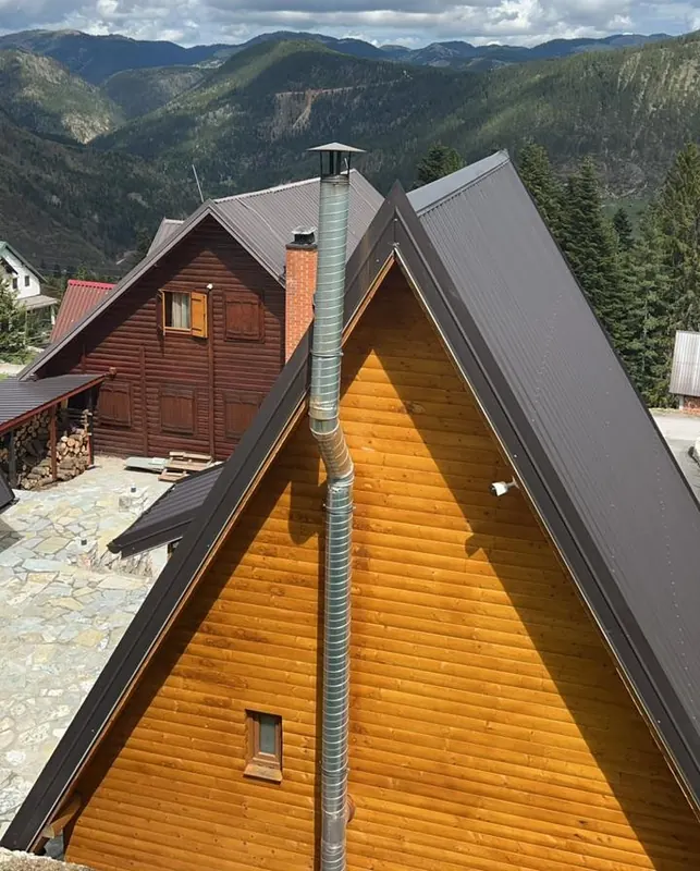 Green ridges of the Rugova valley seen over the roofs